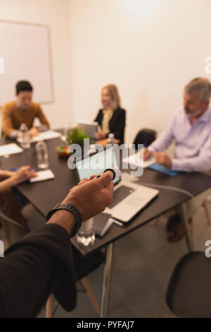 Male executive using projector remote Stock Photo