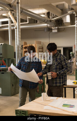 craftsman looking at a blueprint Stock Photo - Alamy