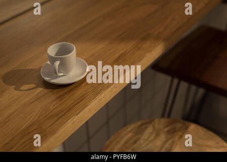 Empty coffee cup on the wooden table in cafe Stock Photo