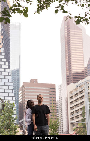 Couple standing together against the city building Stock Photo