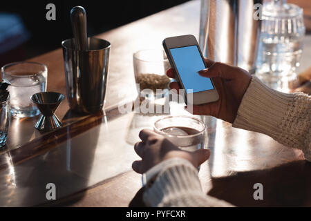 Female worker using mobile phone Stock Photo