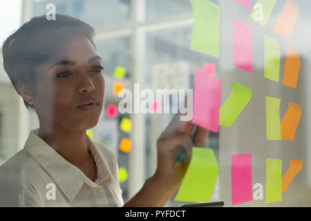 Business executive working on sticky notes Stock Photo