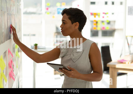 Business executive working on sticky notes Stock Photo