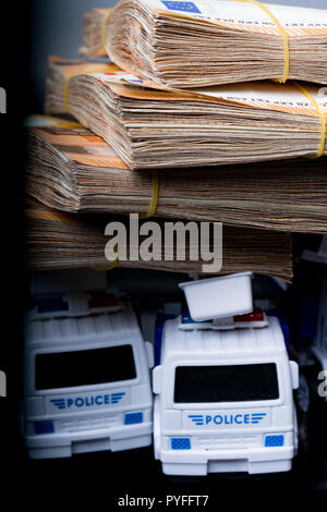 Police corruption in money. Police cars in euros. Crisis in money, bribe and corruption concept Stock Photo