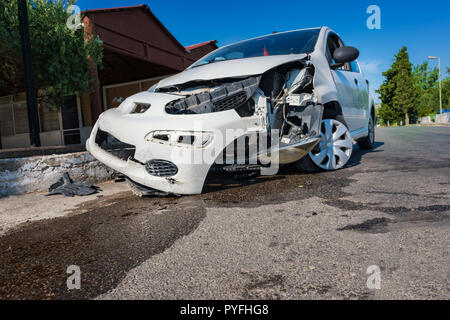 Close-up of crashed car after accident on road in city, sunny day Stock Photo