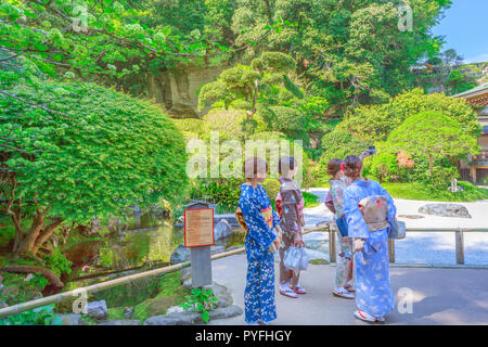 Kamakura, Japan - April 23, 2017: Take-Dera Hokoku-ji Buddhist temple with groups of women in classic kimonos taking pictures in the zed garden. Kamakura, Kanagawa Prefecture, Japan. Stock Photo