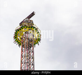 Yo yo carnival ride on cloudy sky background. Oktoberfest, Munich, Germany Stock Photo
