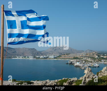 Greek flag flowing over sort in Rhodes, Greece Stock Photo