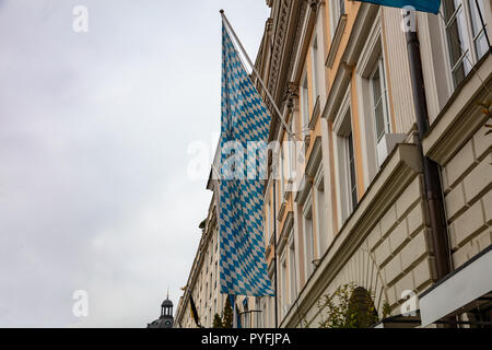 Oktoberfest, Munich. Germany. Bavarian blue white flag on a building facade, cloudy sky background Stock Photo