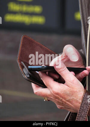 closeup of Womans fingers using mobile phone at Leeds Bradford Airport Yeadon West Yorkshire England Stock Photo