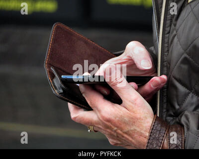 closeup of Womans fingers using mobile phone at Leeds Bradford Airport Yeadon West Yorkshire England Stock Photo