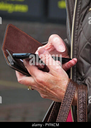 closeup of Womans fingers using mobile phone at Leeds Bradford Airport Yeadon West Yorkshire England Stock Photo