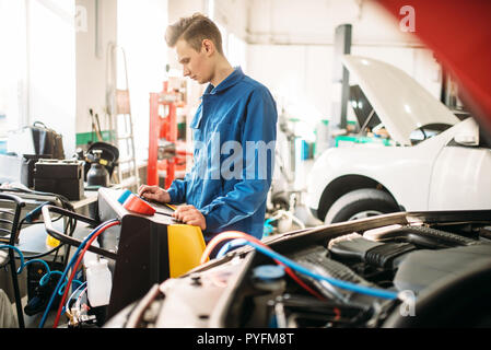 Mechanic checks air conditioning system in car. Conditioner inspection, diagnostic Stock Photo