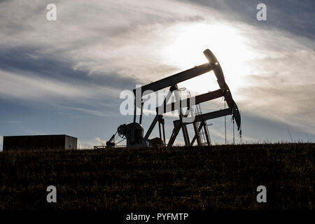 Trio of oil pumpjacks working north of Cochrane, Alberta Canada Stock Photo