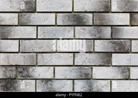 Texture of wall from old burnt gray bricks, close-up Stock Photo