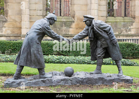 “All together now” statue by Andy Edwards, World War 1 Christmas truce when soldiers played football. St Luke's 'Bombed Out' Church, Liverpool, UK