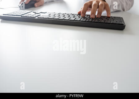 Businessman using computer keyboard and a mouse, with copy space. Stock Photo