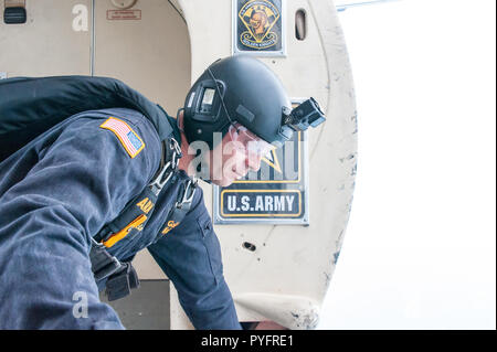 Member of the US Army Golden Knights Parachute Team looking out of the Twin Otter plane, preparing for his jump. Stock Photo