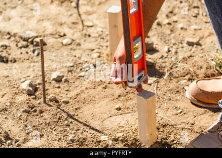 Worker Using Level At Constrcution Site Stock Photo