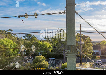 New steel poles and overhead wiring on the Sydney Trains network near Gordon Station on Sydney's leafy north shore T1 line. Stock Photo