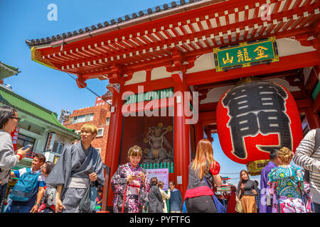 Tokyo, Japan - April 19, 2017: crowded people in front to red giant lantern of Kaminarimon Gate in Senso-ji, the oldest temple in Tokyo, Asakusa. The Japanese word on the lantern means THUNDER GATE. Stock Photo