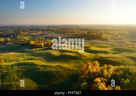 Flying over fields surrounding Vilnius city on sunny autumn evening. Vilnius is one of the few European capital cities, where hot air balloons are all Stock Photo