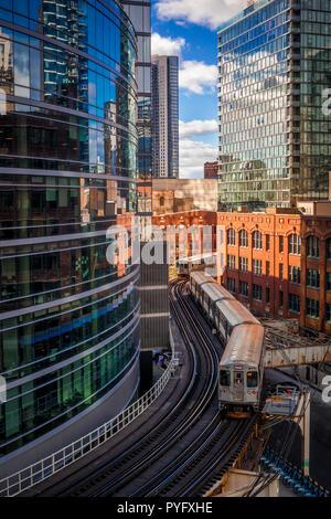 A commuter train winding  on curved elevated tracks in downtown Chicago Stock Photo