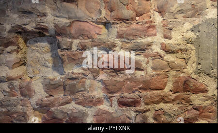 Red and gray natural stone masonry wall, texture grunge background. Stock Photo