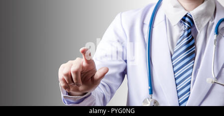 doctor holding index finger to touching screen on gray background with clipping path Stock Photo
