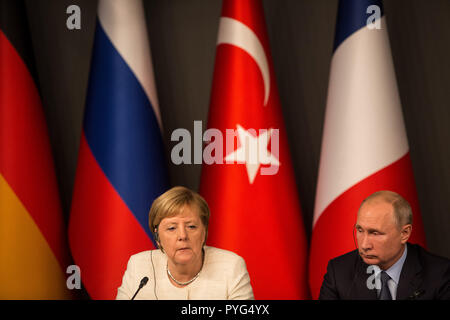 Istanbul, Turkey. 27th Oct, 2018. German Chancellor Angela Merkel (L) and Russian President Vladimir Putin attends a press conference following the 'Four-way Istanbul summit on Syria at Vahdettin Mansion. The summit hosted by Turkish President Recep Tayyip Erdogan, and participation of Russian President Vladimir Putin, German Chancellor Angela Merkel, and French President Emmanuel Macron. Credit: Oliver Weiken/dpa/Alamy Live News Stock Photo