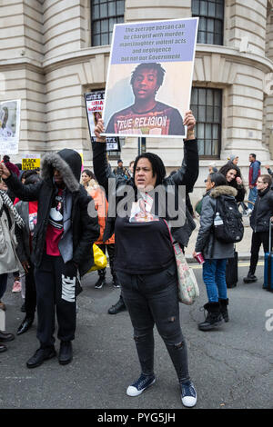 London, UK. 27th October, 2018. Karla Mohammed, mother of Mzee Mohammed, stands with campaigners from the United Families and Friends Campaign (UFFC) taking part in the 20th annual procession to Downing Street in remembrance of family members and friends who died in police custody, prison, immigration detention or secure psychiatric hospitals. Mzee Mohammed, 18, died in July 2016 after being detained by Merseyside police at the Liverpool One shopping centre. Credit: Mark Kerrison/Alamy Live News