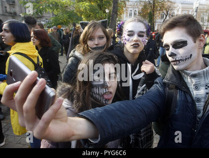 Kiev, Kiev, Ukraine. 27th Oct, 2018. Participants are seen taking a selfie photo in zombie costumes and make-up during the celebrations.Hundreds of people marched through the streets in Kiev downtown, on the eve of the Halloween zombie celebrations. Credit: Pavlo Gonchar/SOPA Images/ZUMA Wire/Alamy Live News Stock Photo
