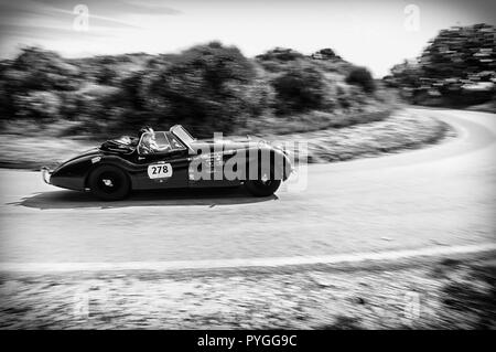 PESARO COLLE SAN BARTOLO, ITALY - MAY 17 - 2018: JAGUAR XK 120 DHC 1953 old racing car in Mille Miglia rally 2018 the famous italian historical race ( Stock Photo