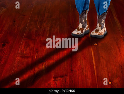 Cowboy boots with log shadow and room for your type. Stock Photo