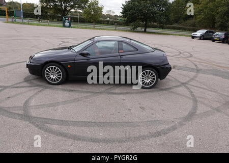 Alfa Romeo GTV donut tyre marks in car park Stock Photo