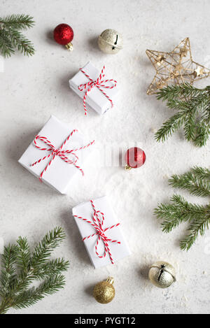 Christmas composition with Gift Boxes, fir branches, golden balls on white background. Christmas festive concept. Stock Photo