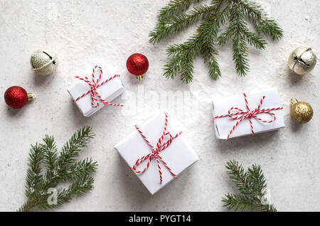 Christmas composition with Gift Boxes, fir branches, golden balls on white background. Christmas festive concept. Stock Photo