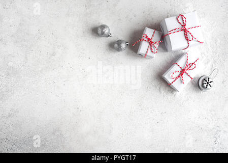 Christmas Gift Boxes on white background, copy space. White Christmas Gifts and silver balls, festive composition, concept. Stock Photo