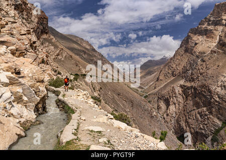 Trekker admires up valley views of Engels Peak on the Engels Peak Meadows trek, Langar, Tajik Wakhan, Pamir Mountains, Tajikistan Stock Photo