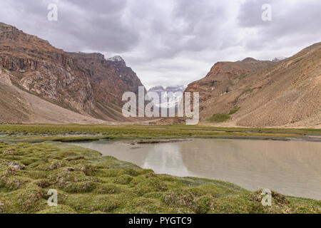 Reflection of Engels Peak seen from the Engels Peak Meadows, Langar, Tajik Wakhan, Pamir Mountains, Tajikistan Stock Photo