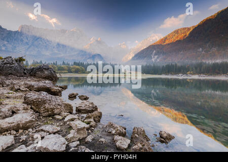 Cold and foggy sunrise over Fusine Lakes in Italy. Stock Photo