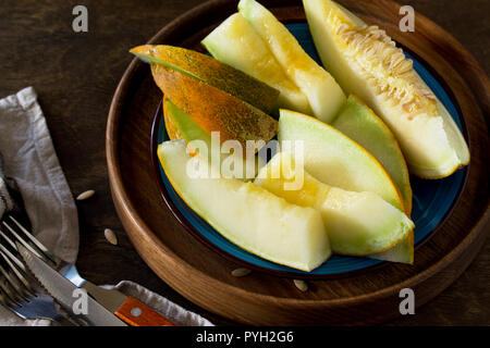 Melon. Fresh sliced melon in  a plate on  the wooden table.