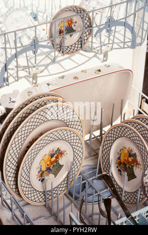Brightly patterned china in a residential dishwasher, USA
