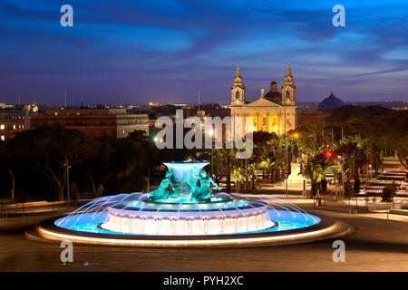 Night view at the Triton Fountain near the city gates of Valletta, Malta Stock Photo