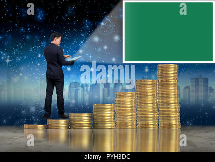 Asian Businessman standing on the stack of gold coins and using the tablet present the green screen over cityscape and star background, Business virtu Stock Photo