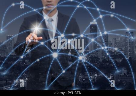 Businessman pointing with digital network line and circles over Top view of Bangkok Cityscape at twilight time background, business technology concept Stock Photo
