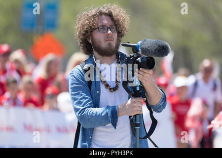 Chicago, Illinois, USA - May 5, 2018: The Polish Constitution Day Parade, cameraman recording video during the parade Stock Photo