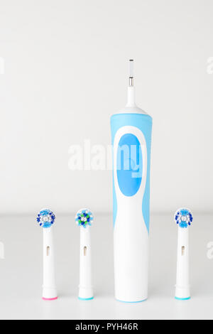 Electric toothbrush and spare brush heads on white background, close up Stock Photo