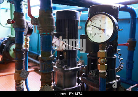 A pressure gauge on the pipeline showing the water pressure after the electric pumps. Stock Photo