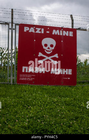 Warning sign for landmines in the reproduction of a minefield at the Sarajevo Tunnel Museum housing the 1993 underground tunnel built during the Siege Stock Photo